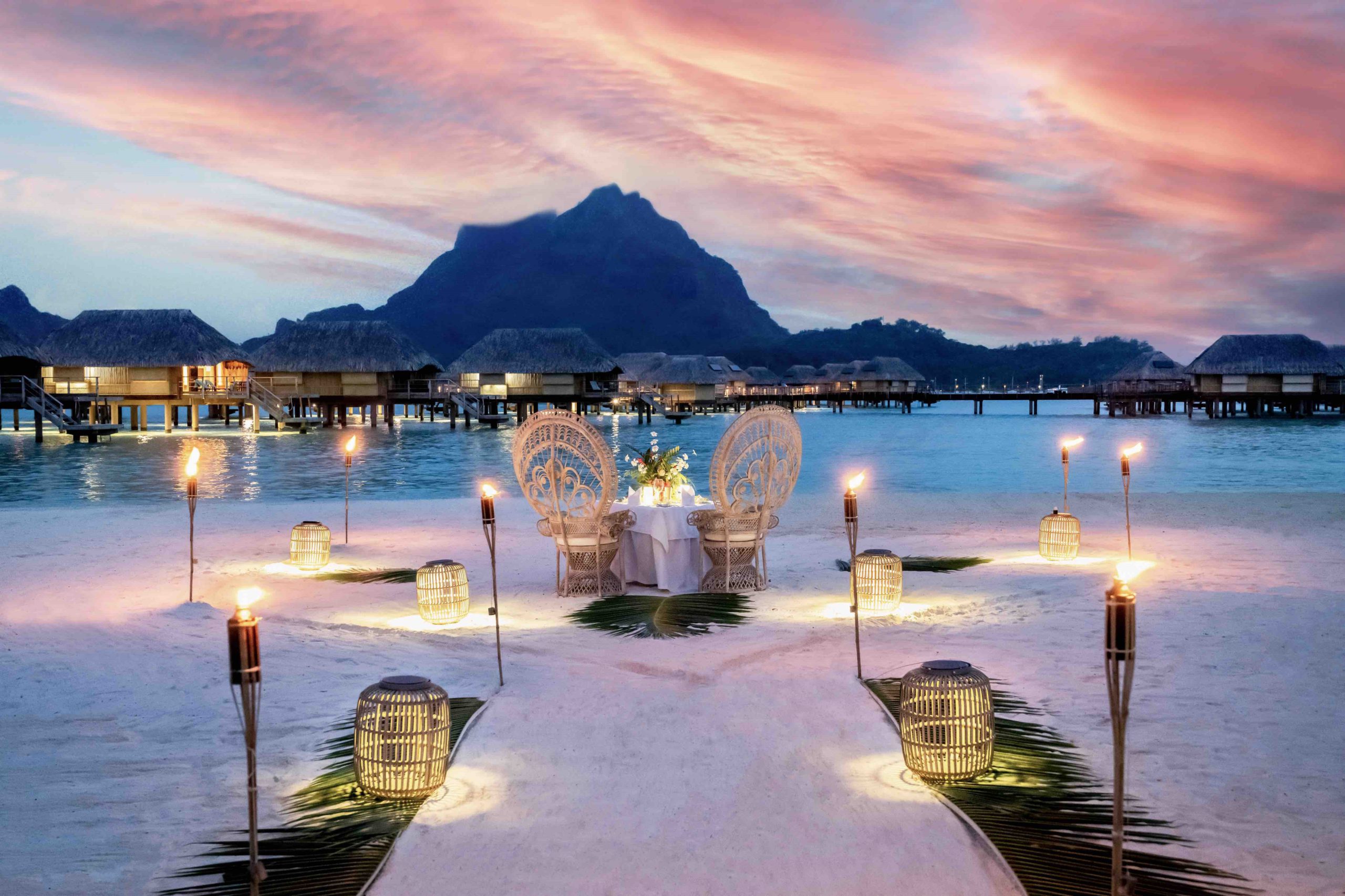 A candlelit dinner for two on the sand