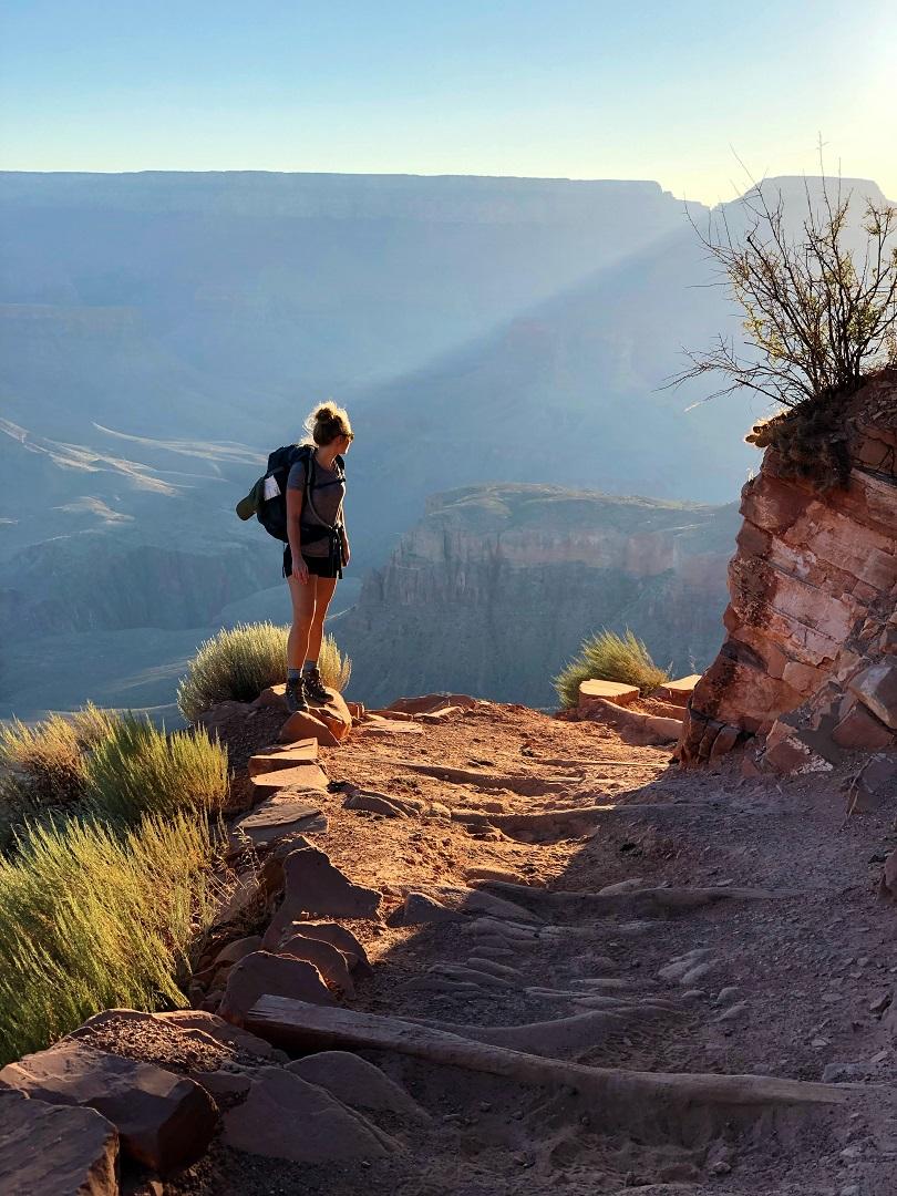 A traveler above the canyon at golden hour