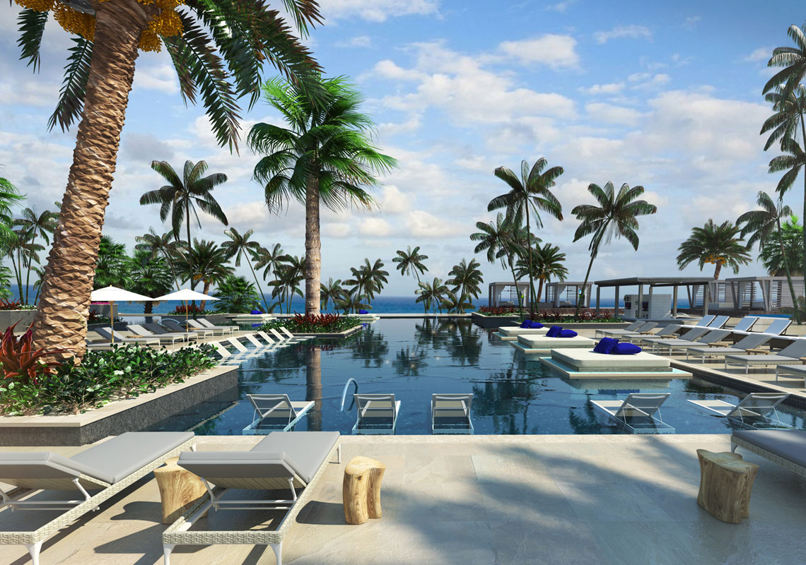 A palm-lined resort pool reaching toward the sea